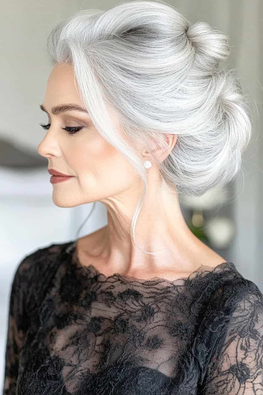 Woman with loose gathered updo in silver hair, exuding effortless charm and sophistication.