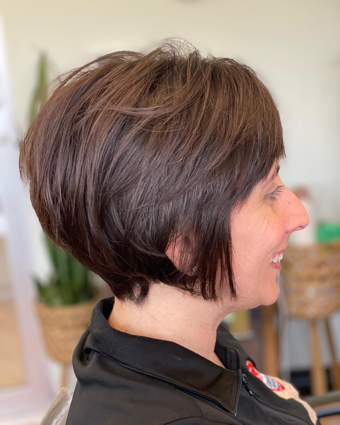 Natural brown bixie with side-swept bangs