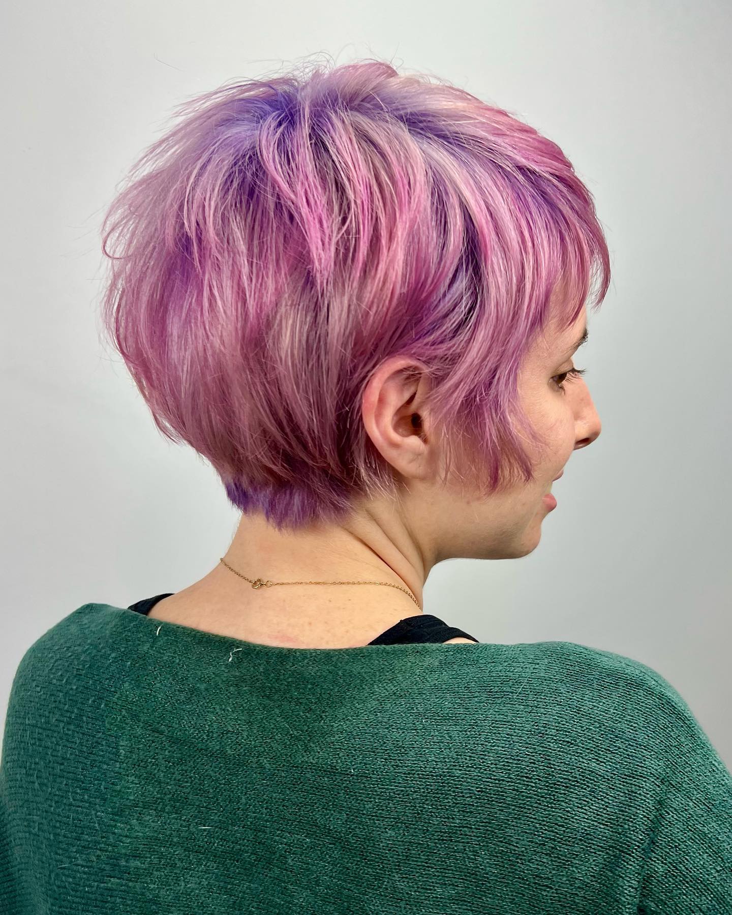 Bixie haircut with pink and purple hues