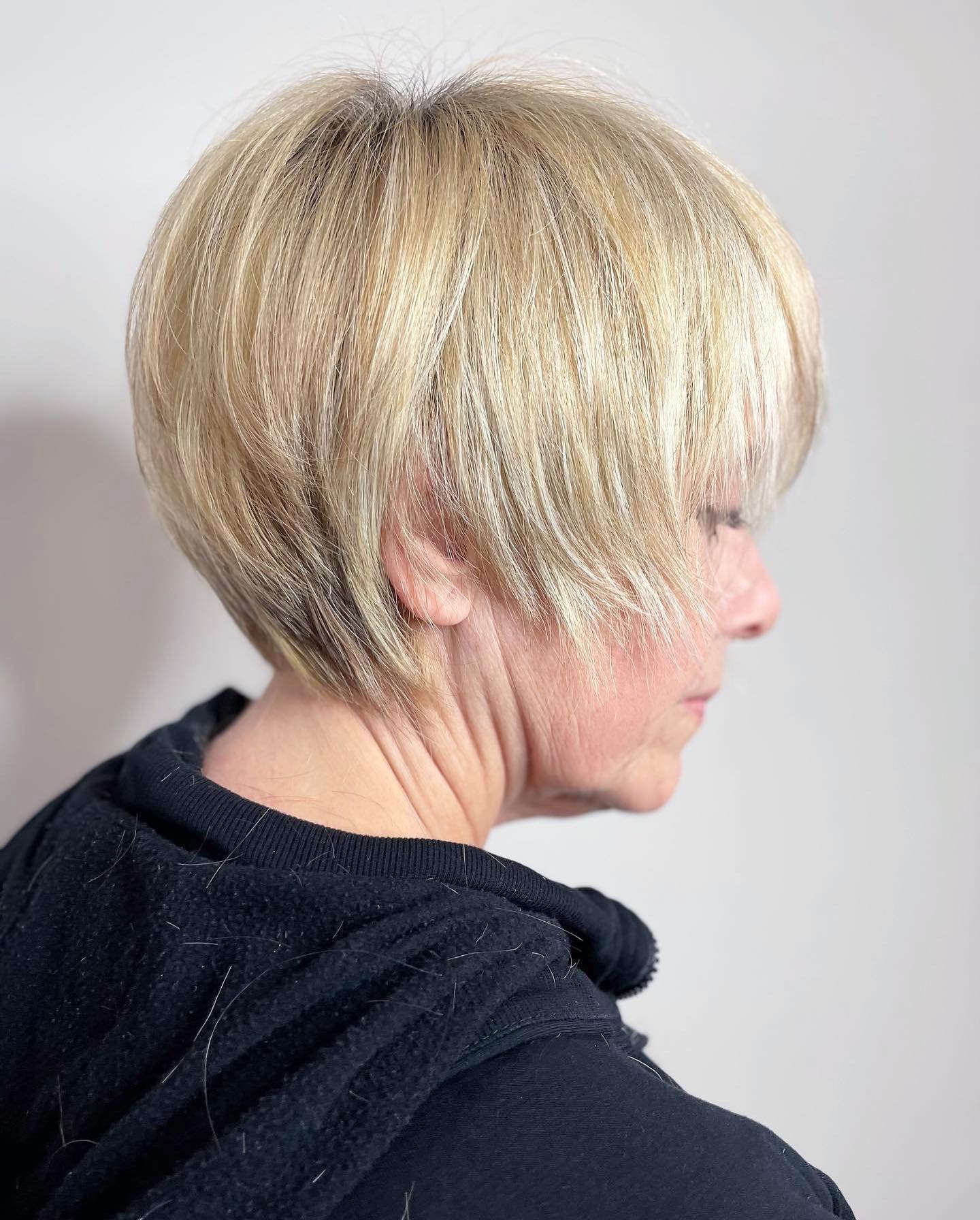 Defined blonde bixie with long bangs