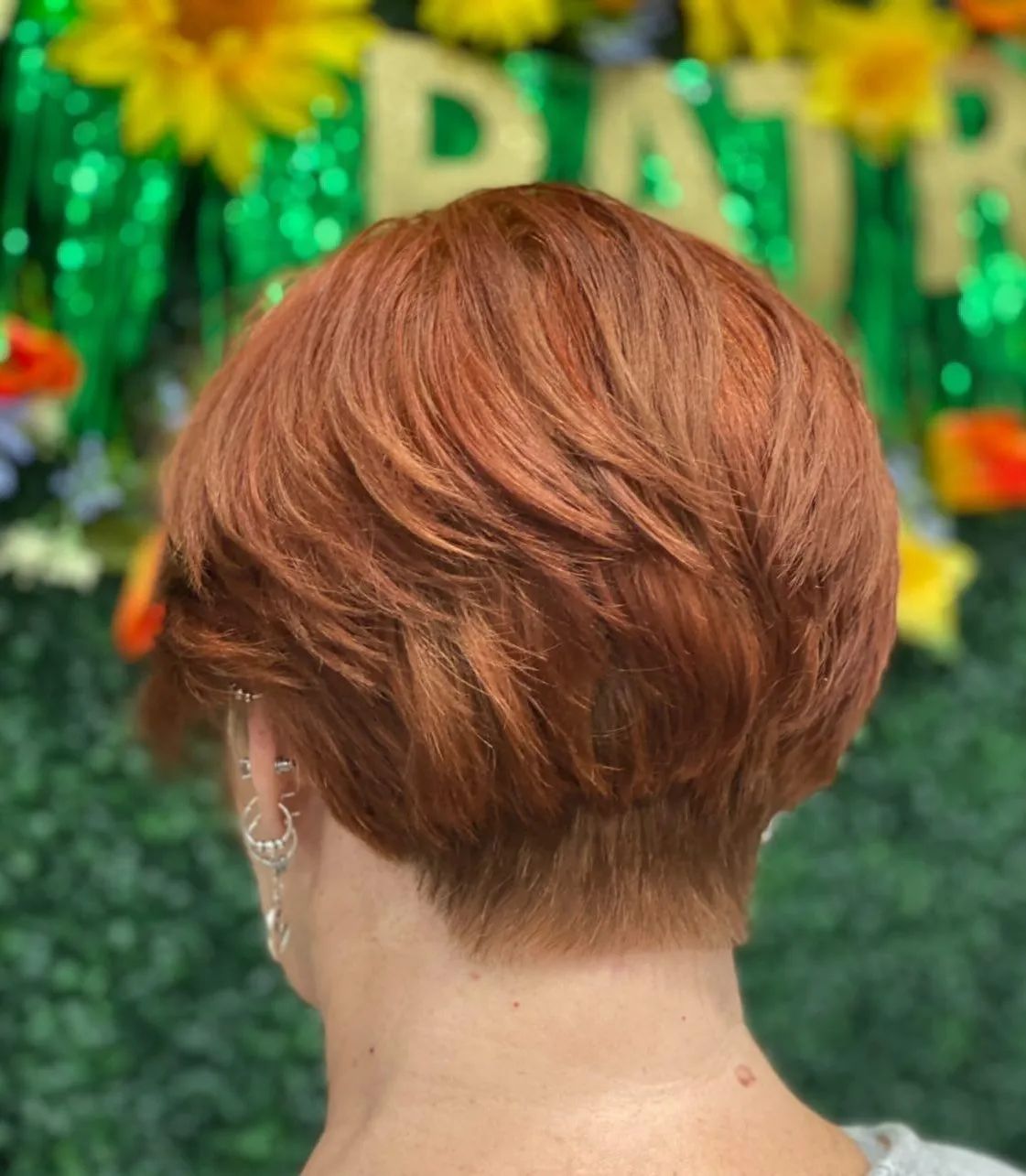 Woman with an auburn bixie haircut
