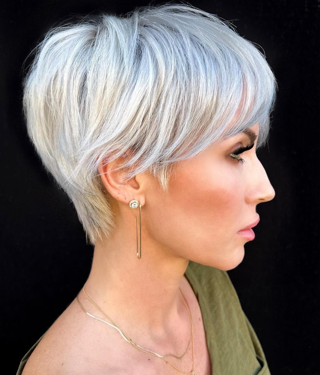 Modern silver bixie cut on a woman with glasses