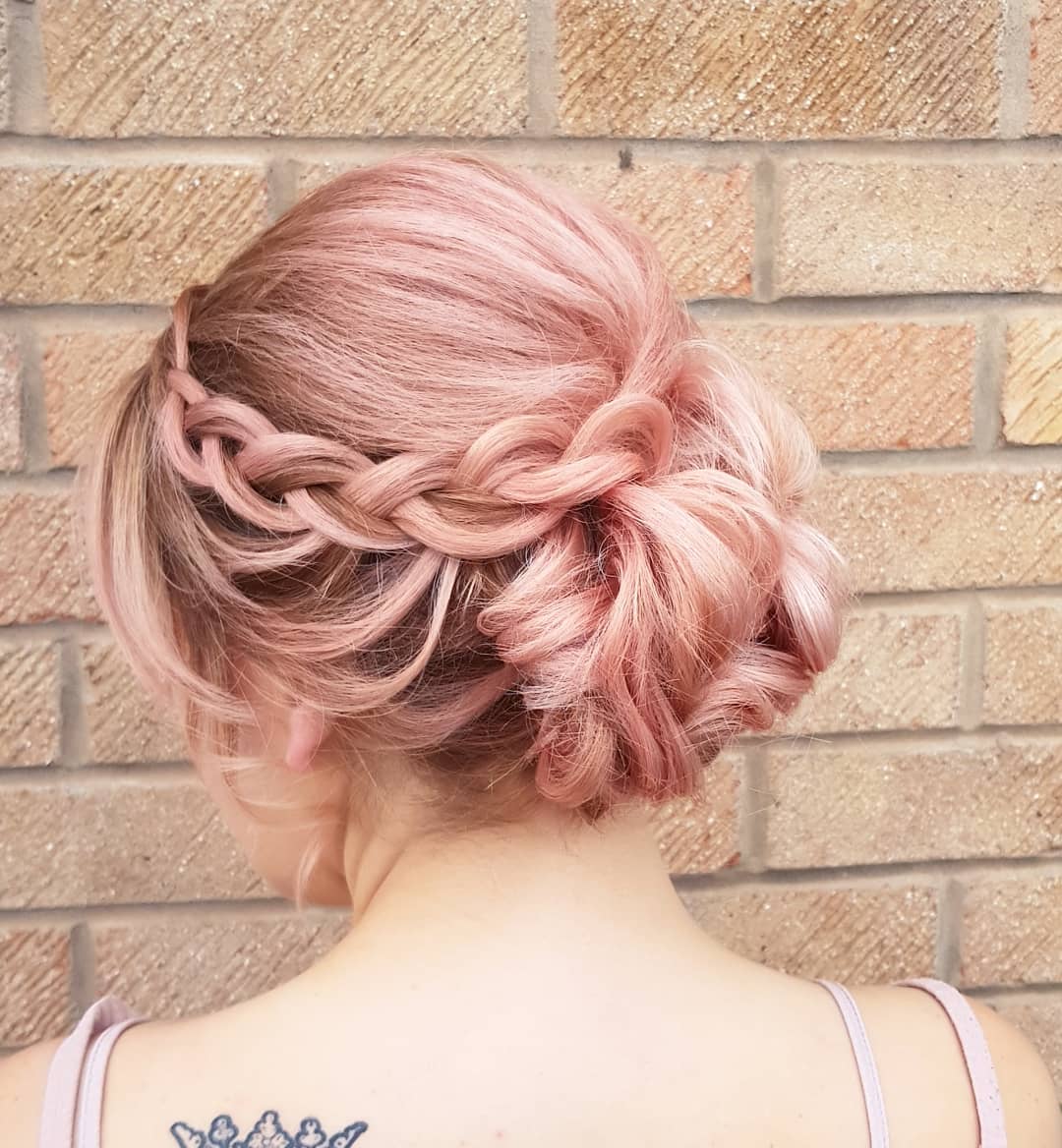 30-messy-bun A messy bun updo with a loose braid incorporated into the side.