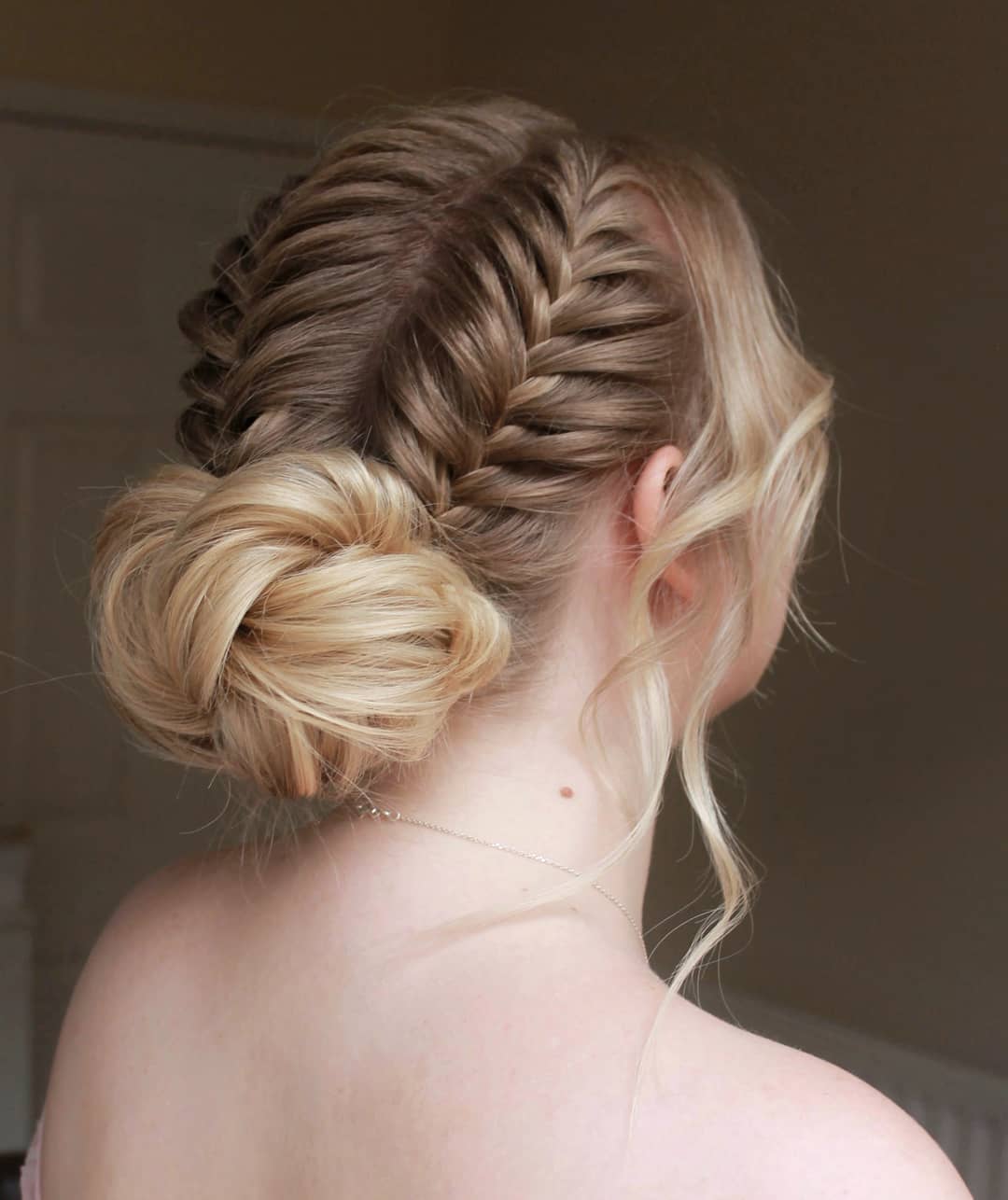 36-boxer-braid-into-low-bun Two dutch braids leading into a low, neat bun.