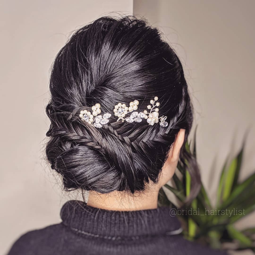 37-low-bun-with-mini-braids A low bun with several mini braids woven throughout the hair.