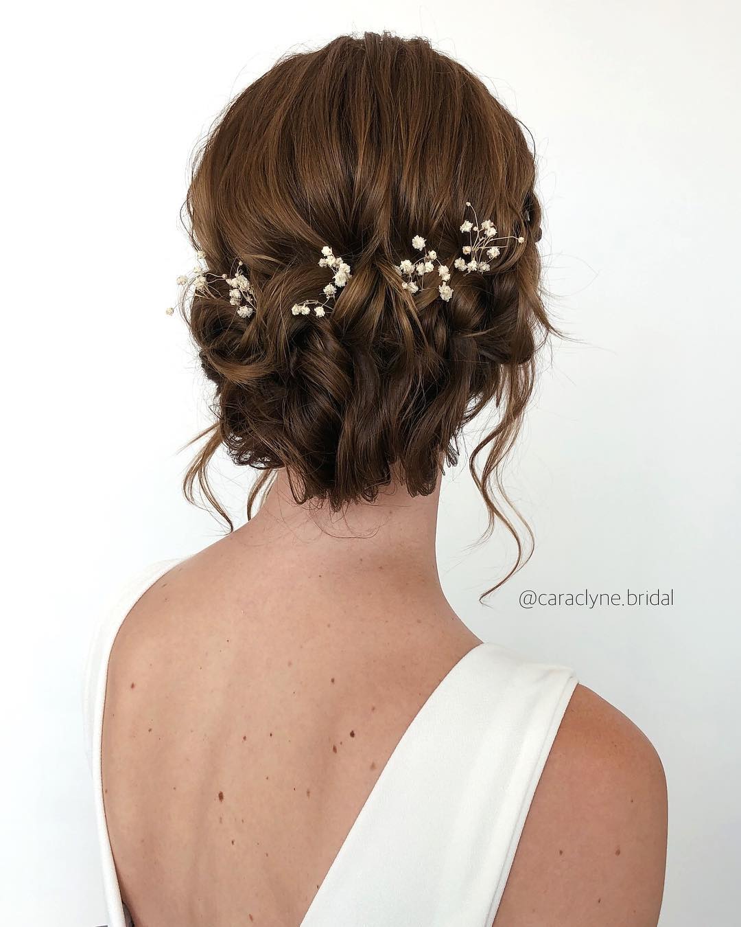5-textured-braid-updo-1 A textured braided updo with pieces of baby's breath tucked in.