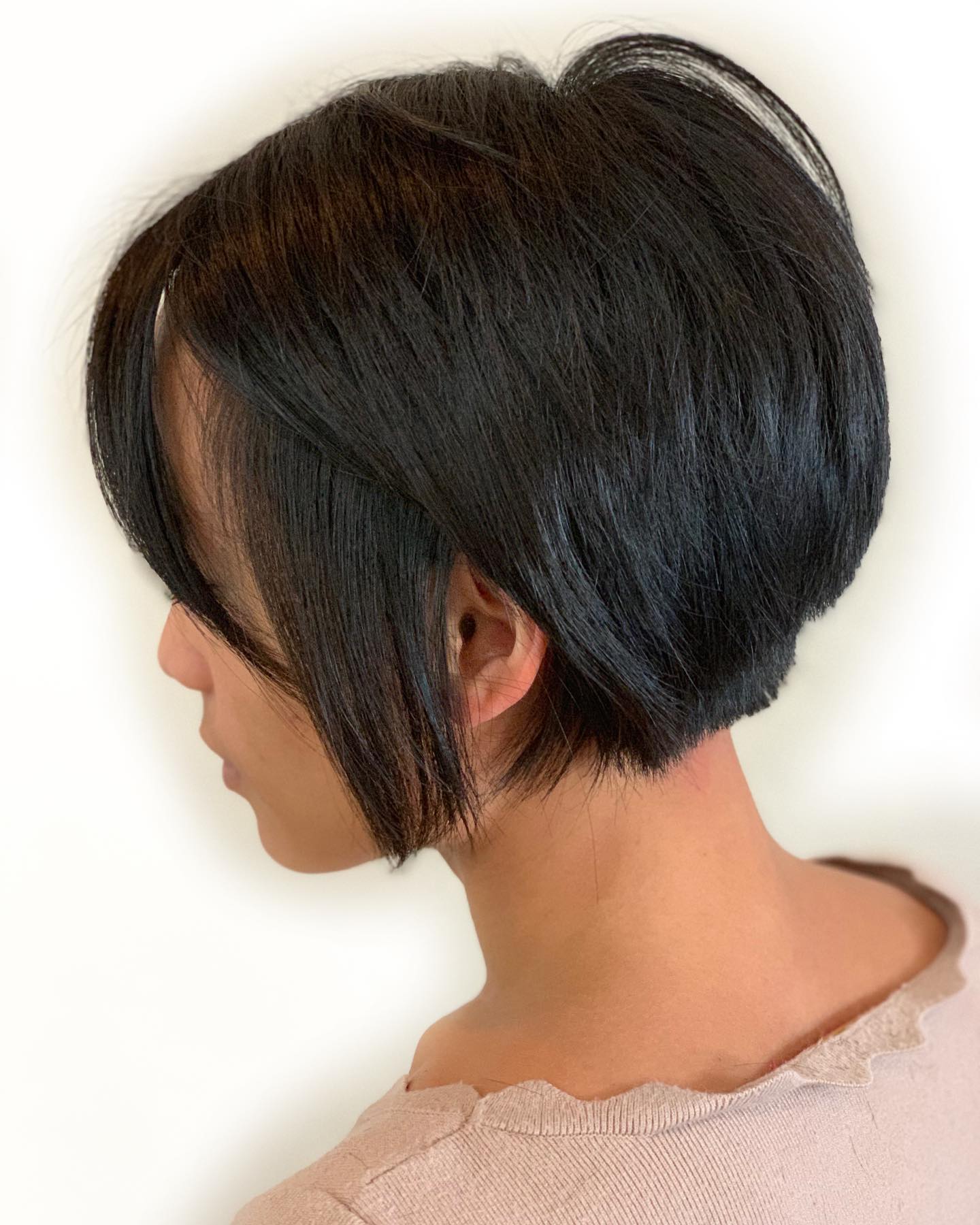 Dark brown, almost black, bixie hairstyle on a woman