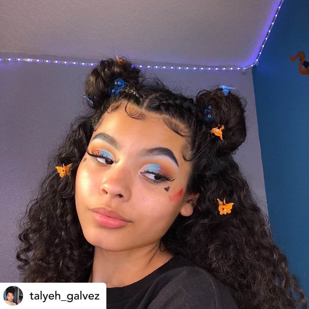 Instagram baddie with butterfly clips and space buns.