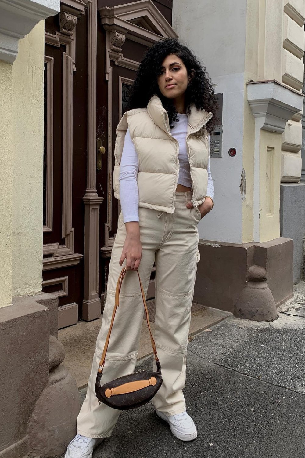 Puffer vest with crop top and jeans