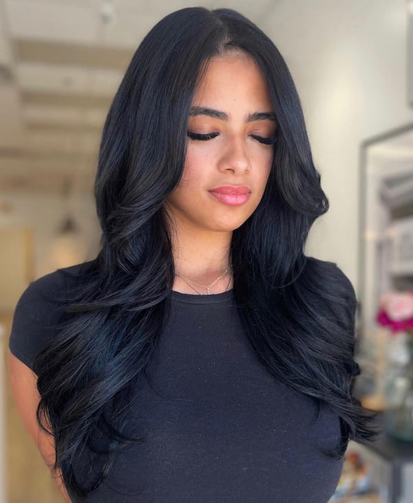 Centre-Parted Mid-Length Haircut with Feathered Coil