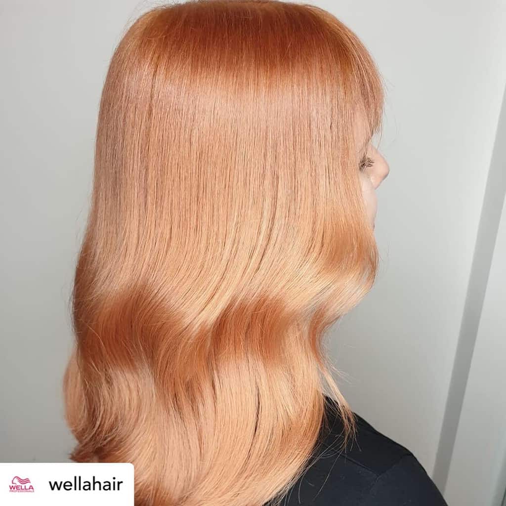 Woman with beautiful blorange hair color.