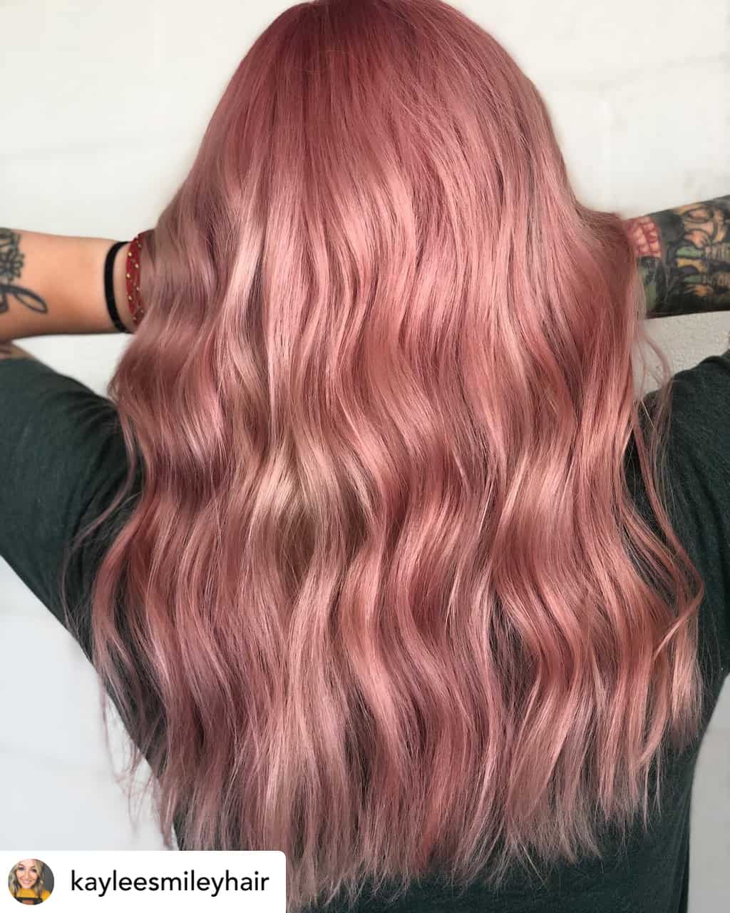 Woman with beautiful rose gold hair color.