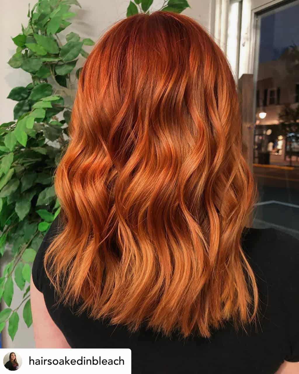 Woman with beautiful pumpkin spice hair color.