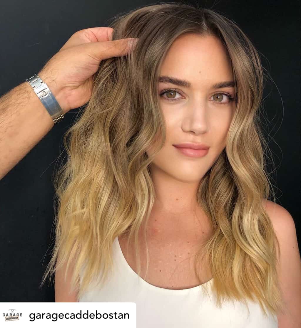 Woman with beautiful honey ombré hair color.