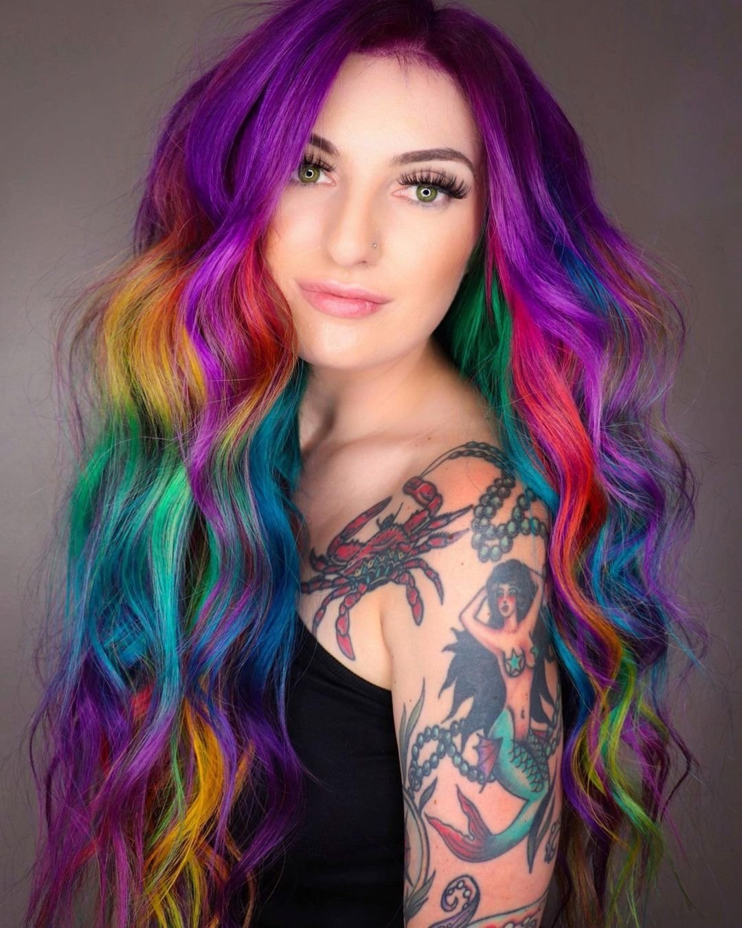 Beautiful rainbow hair color on long wavy hair.