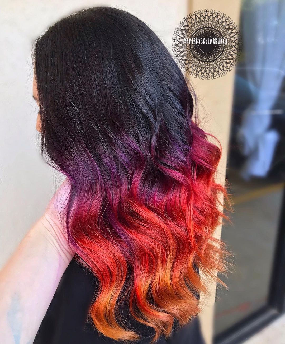 Beautiful sunset ombre hair color on long wavy hair.