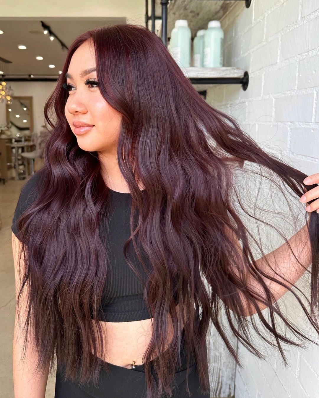 Beautiful chocolate cherry hair color on long wavy hair.