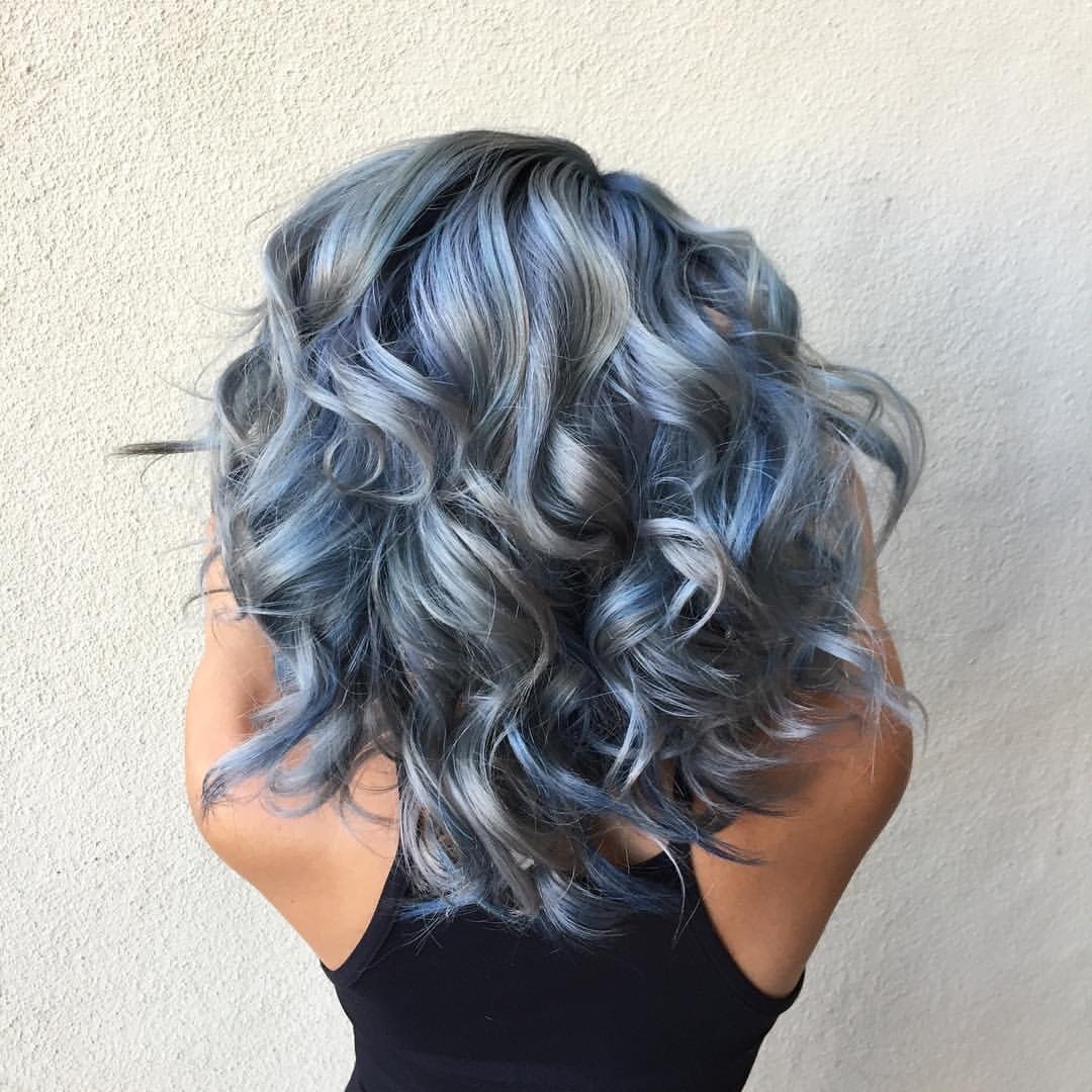 Beautiful silver blue hair color on mid-length curly hair.