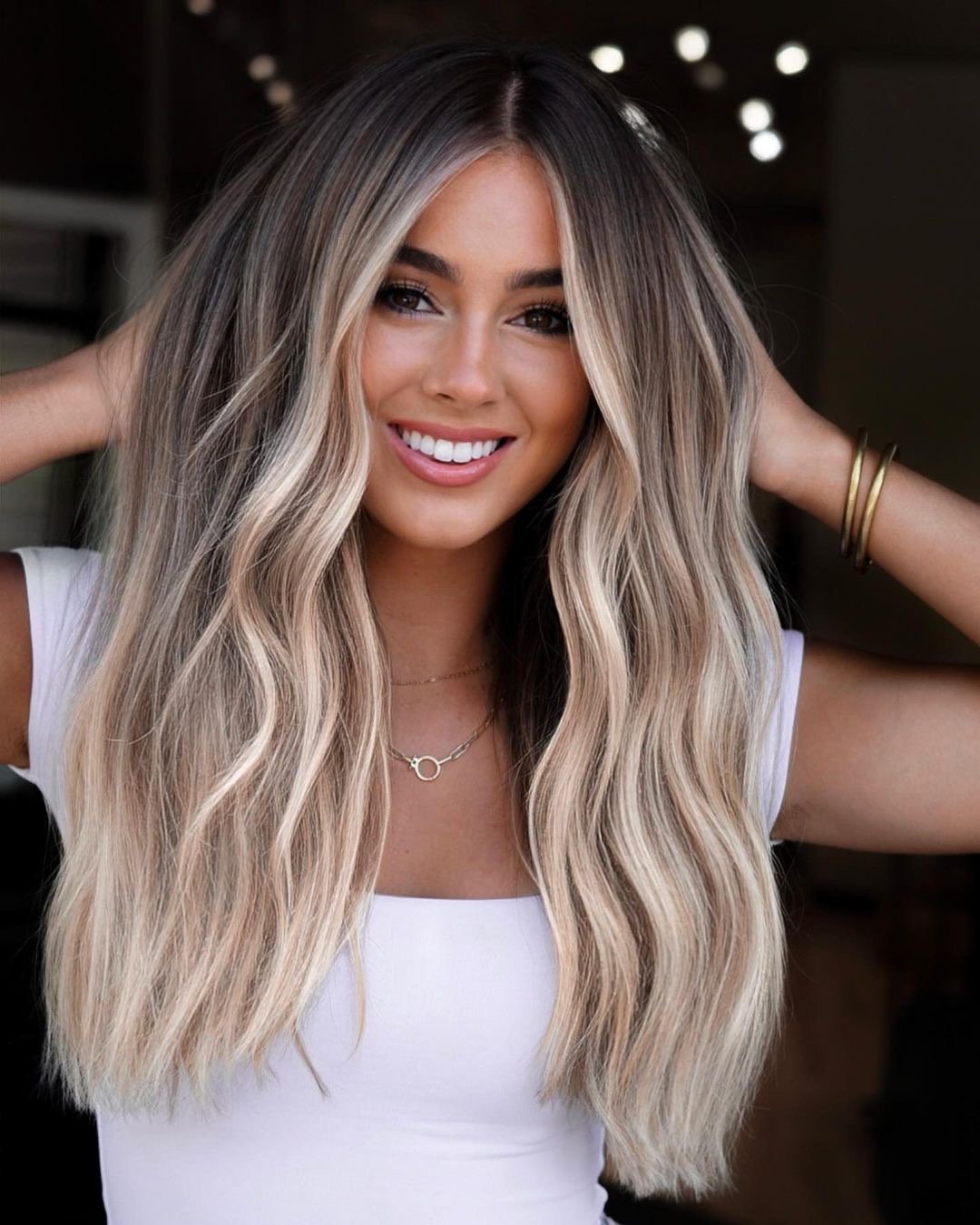 Beautiful bronde hair color on long wavy hair.