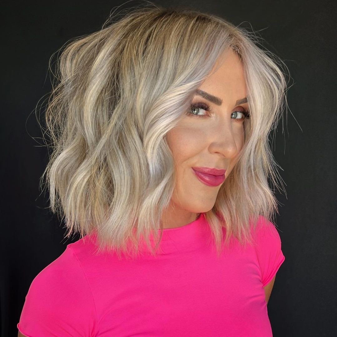 Woman with a gorgeous blonde textured bob haircut.