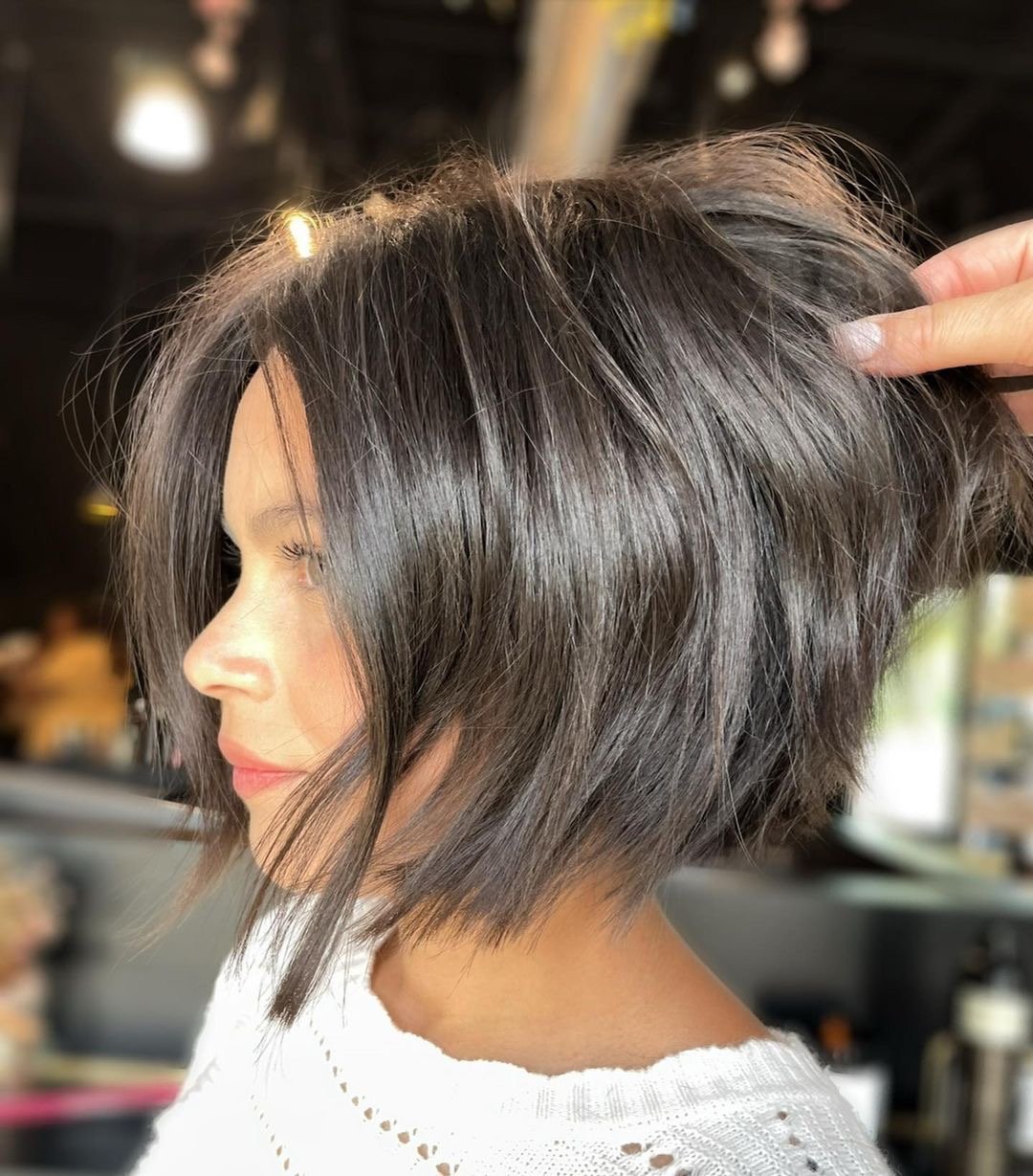 Woman with a gorgeous brunette textured bob haircut.