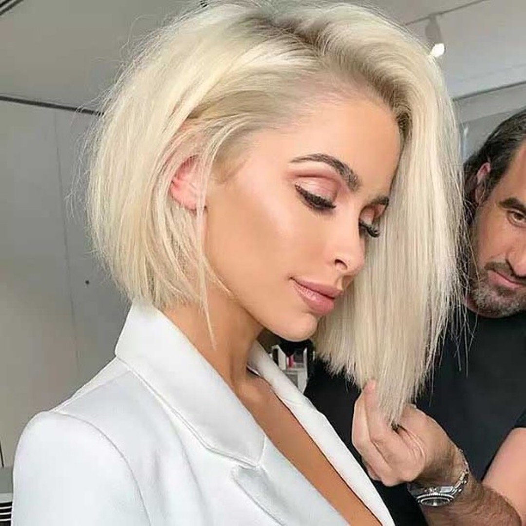 Woman with a gorgeous blonde asymmetrical haircut.