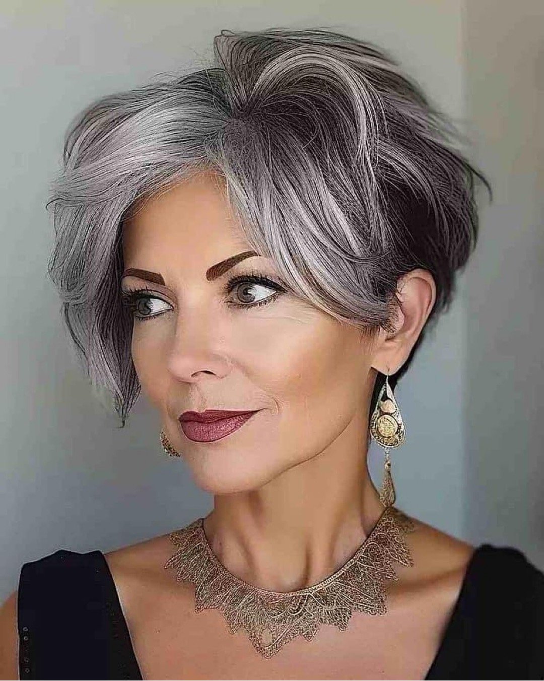 Woman with a gorgeous grey pixie haircut.