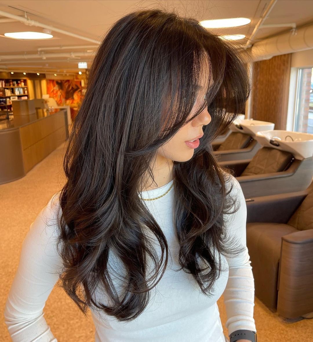 Woman with a gorgeous long layered haircut.