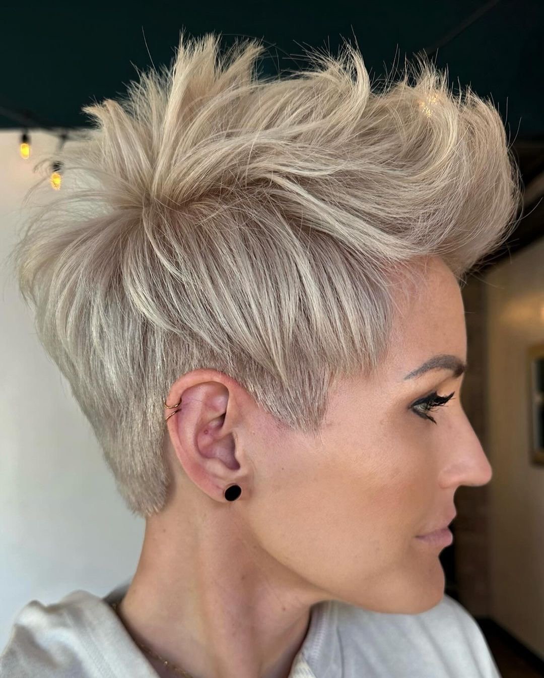 Woman with a gorgeous blonde pixie haircut.
