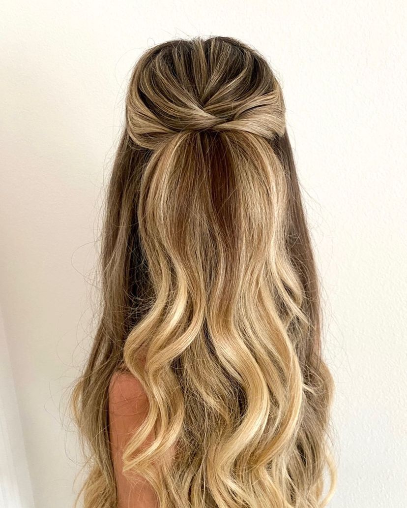 Woman with cute half up half down hairstyle on long hair. Find out what hairstyles are best for every hair type.