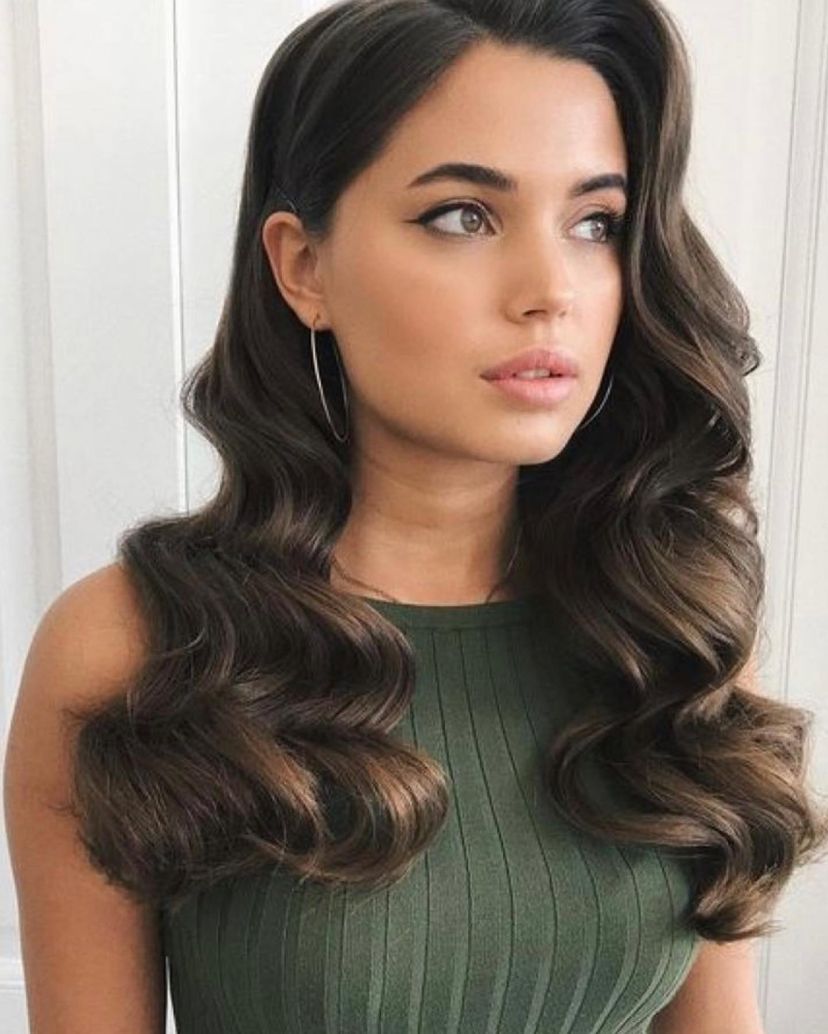 Woman with gorgeous retro waves and side part on mid-length brown hair. Find out what hairstyles are best for every hair type.