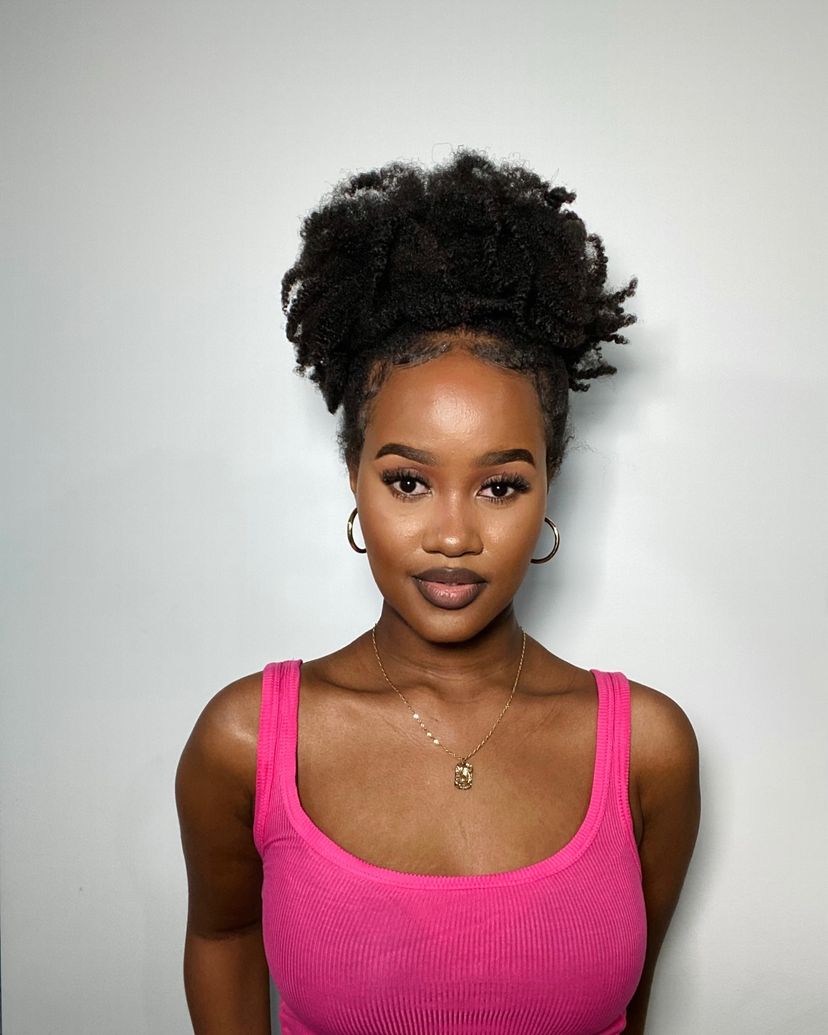 Woman with gorgeous high puff on natural curly hair. Find out what hairstyles are best for every hair type.