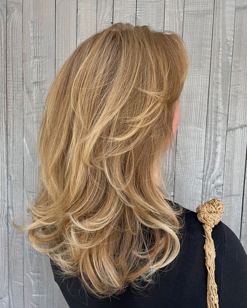 Woman with voluminous blowout on midlength hair. Find out what hairstyles are best for every hair type.