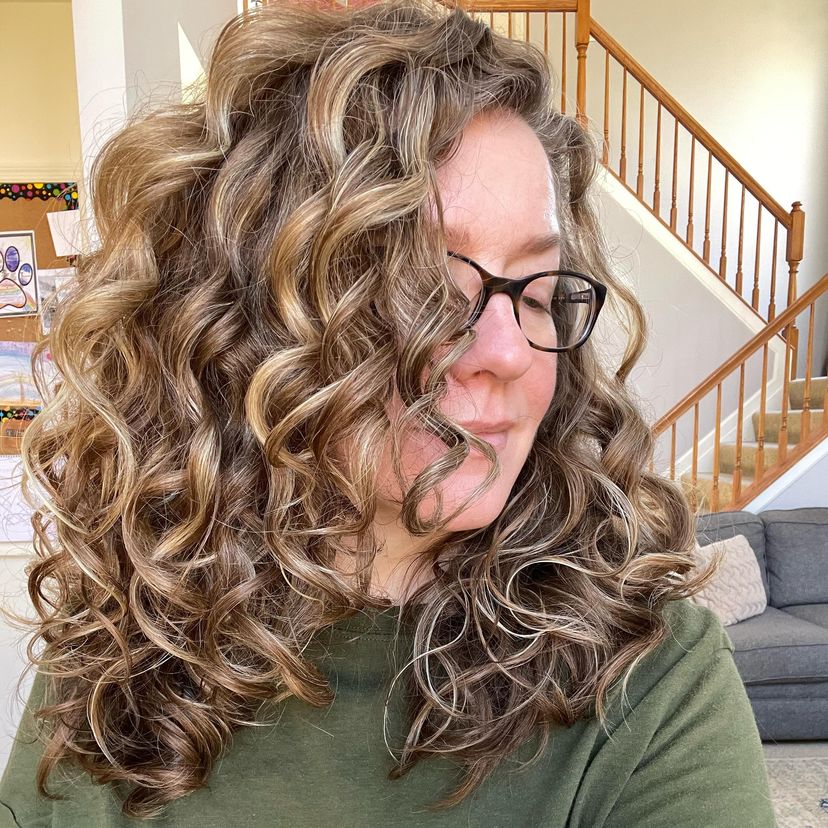 Woman with gorgeous naturally curly hair. Find out what hairstyles are best for every hair type.