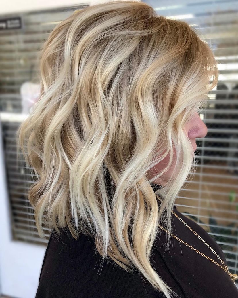 Woman with gorgeous wavy mid-length bob haircut. Find out what hairstyles are best for every hair type.