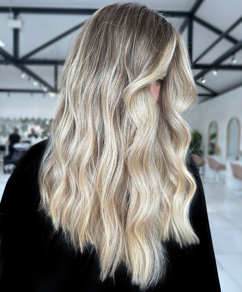Woman with gorgeous long blonde wavy hair. Find out what hairstyles are best for every hair type.
