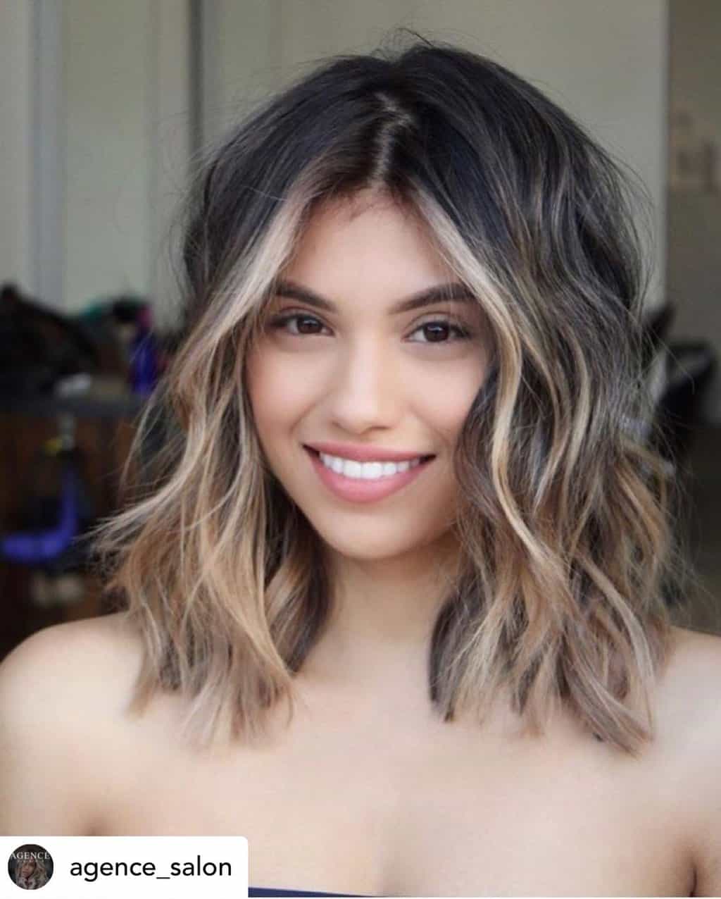 Beautiful woman with long wavy bob and balayage.