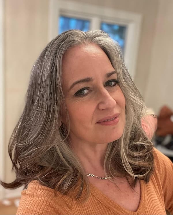 medium-length-gray-haircut-with-blow-out-curls Medium-Length Gray Haircut with Blow-Out Curls