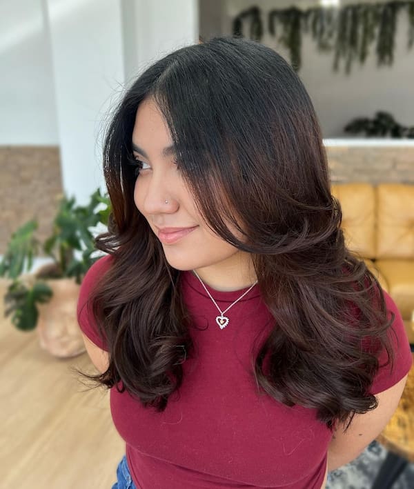 Mid-Length Haircut with Wavy Ends and Curtain Bangs