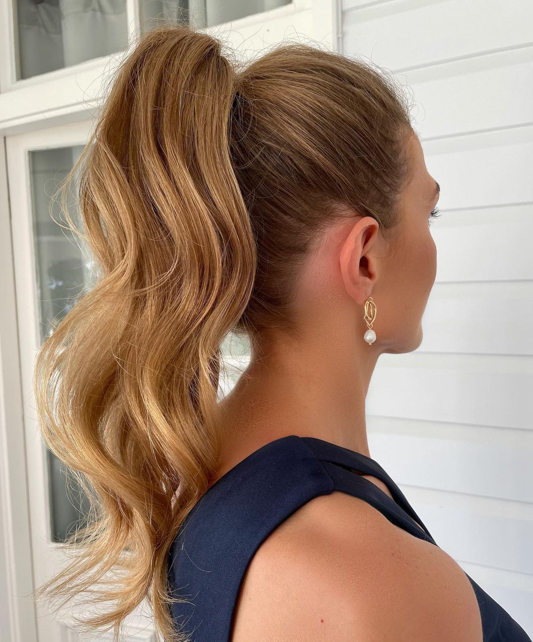 Gorgeous woman with textured high ponytail hairstyle.