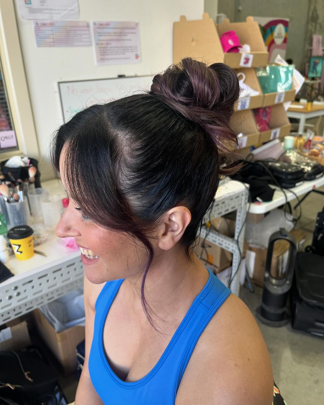 Gorgeous woman with cute topknot hairstyle.