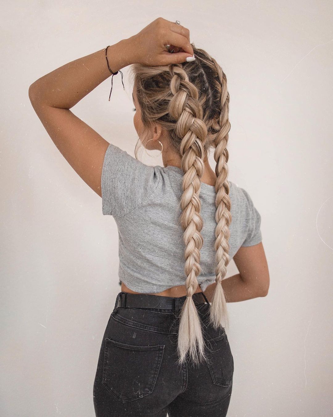 Gorgeous woman with double Dutch braids hairstyle.