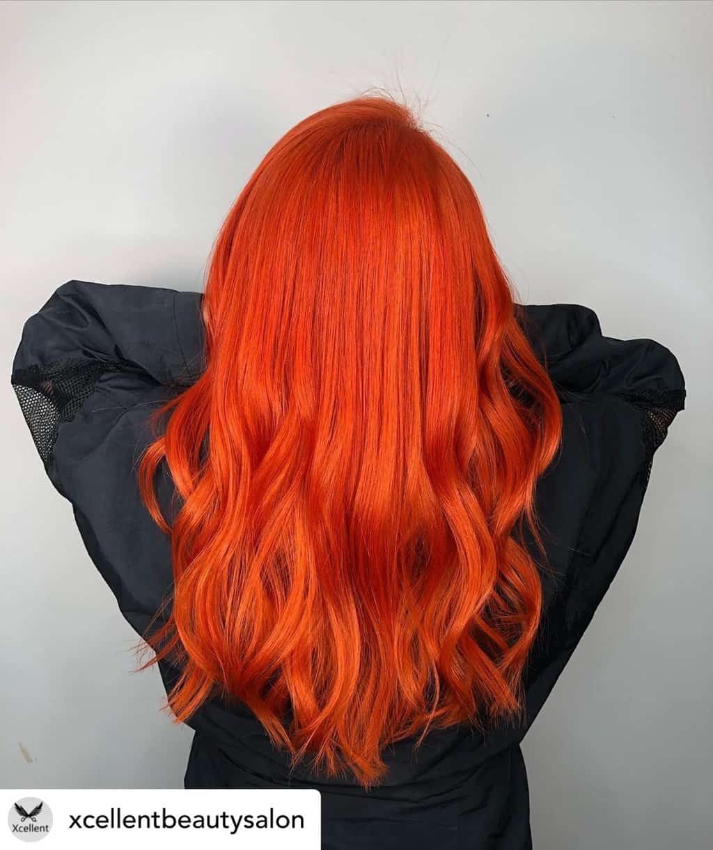 Vibrant orange-red hair.