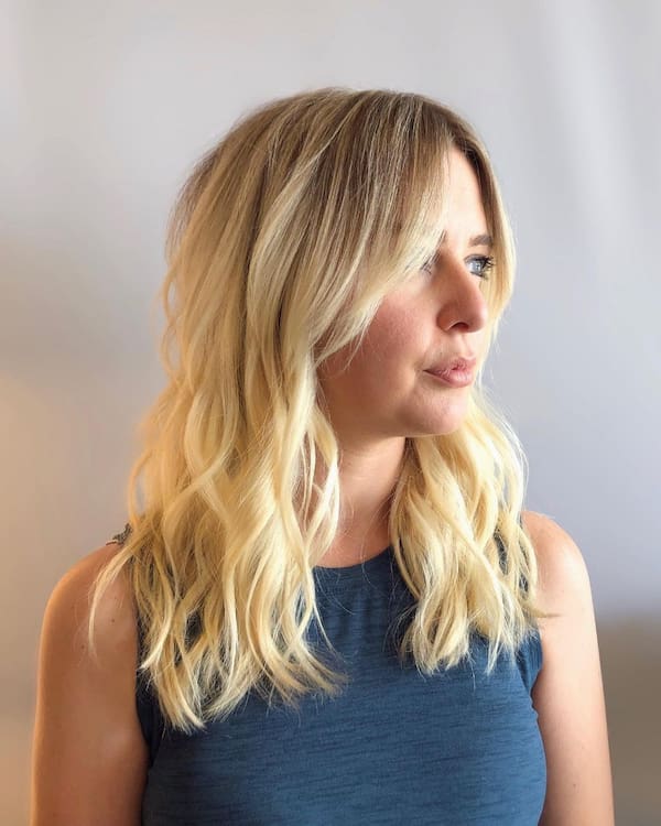 soft-layered-wavy-haircut-with-curtain-bangs Soft Layered Wavy Haircut with Curtain Bangs