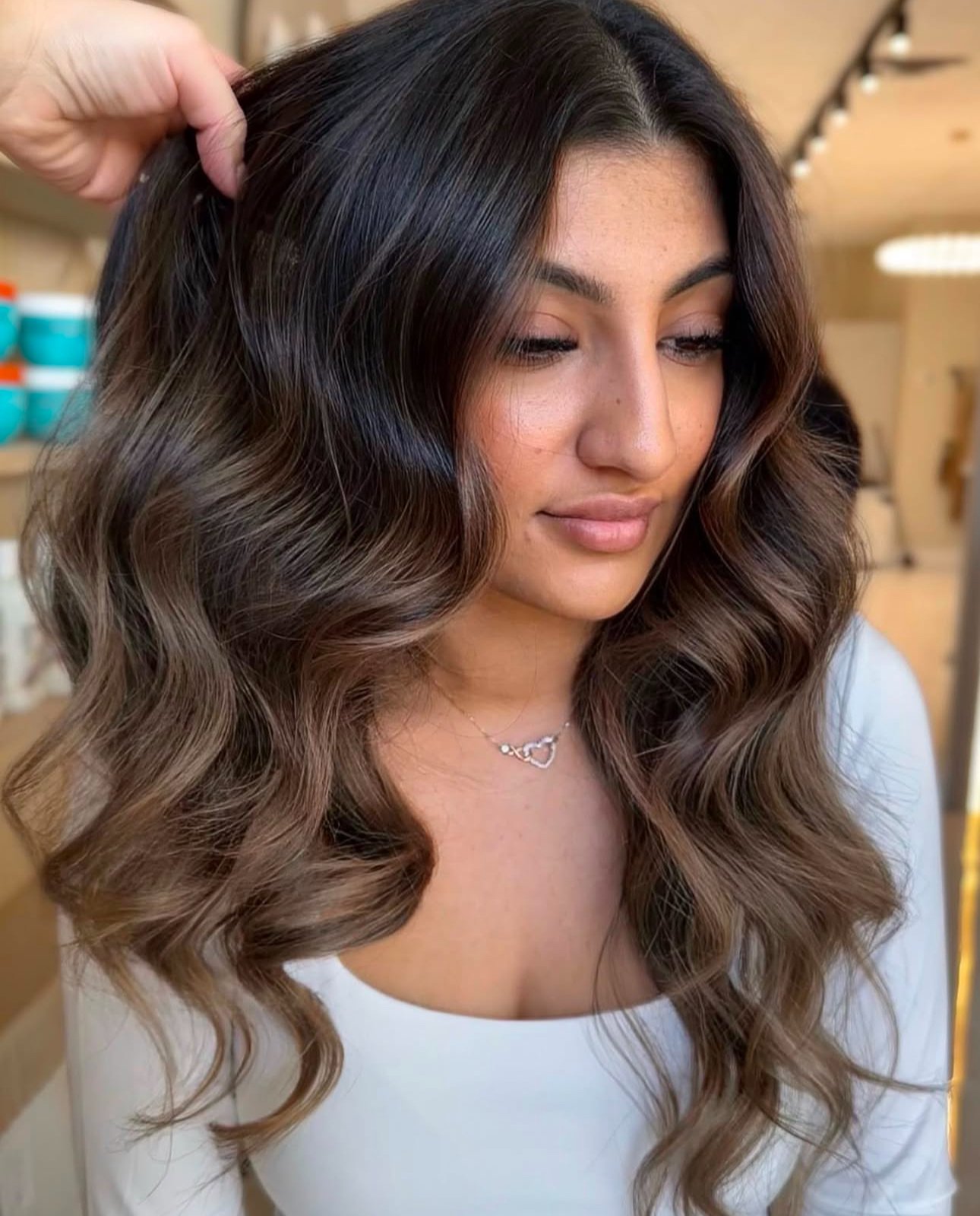 Beautiful woman with rich espresso brown hair color on long wavy hair.