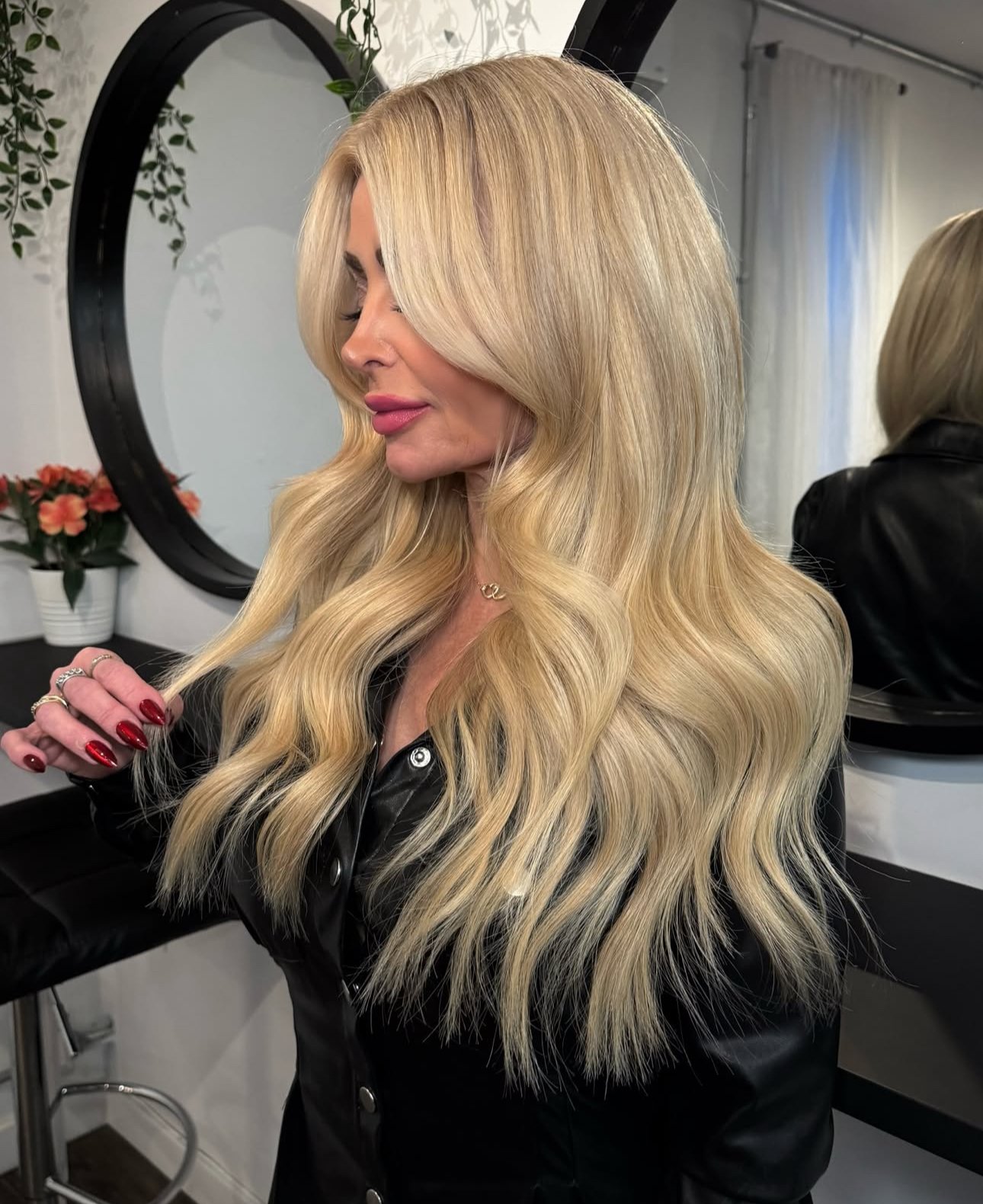 Beautiful woman with gorgeous champagne blonde hair color on long wavy hair.