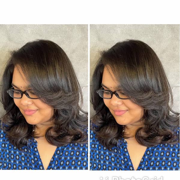 Stylish Neck-Length Haircut with Curly Ends and Feathered Layers