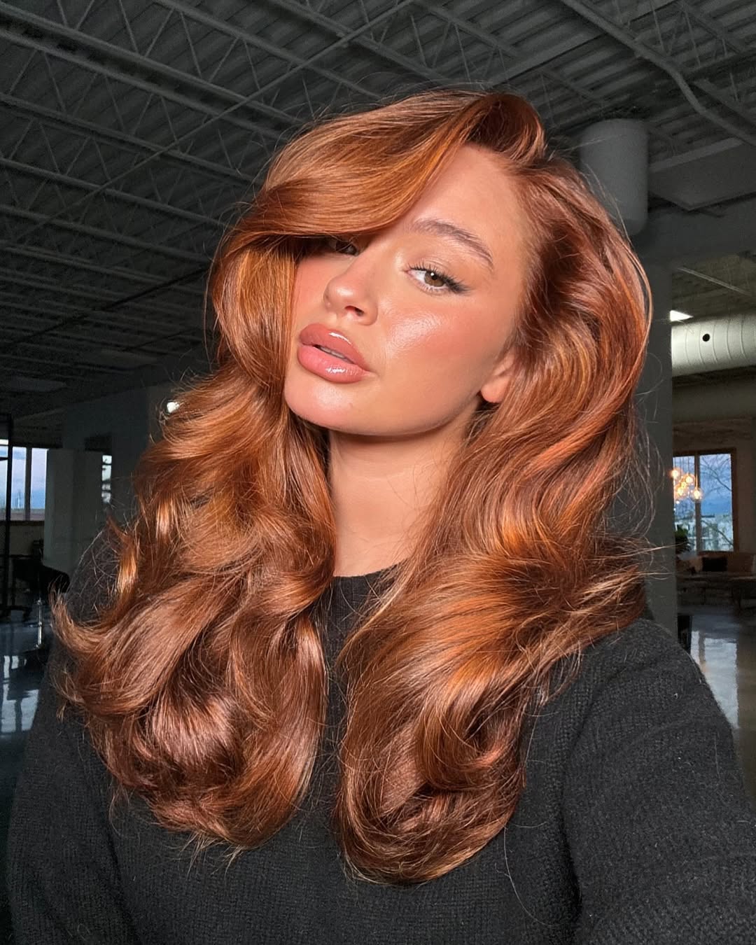 Gorgeous apricot copper hair color on a long layered haircut.