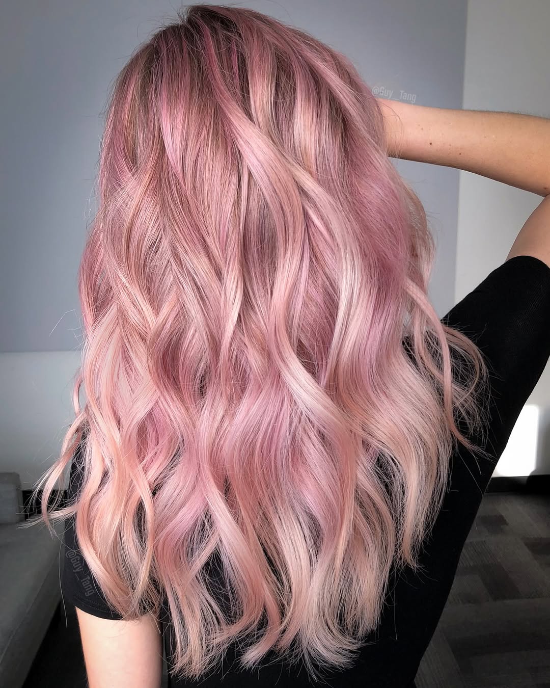 Gorgeous pastel pink hair color on mid-length wavy hair.