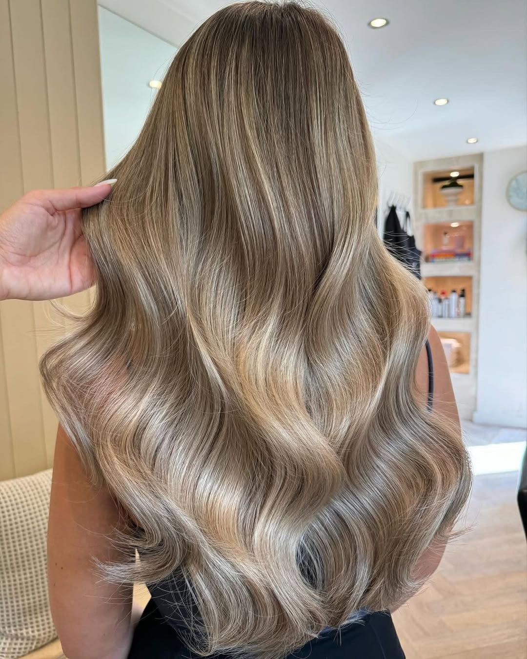 Beautiful linen blonde hair color on long wavy hair.
